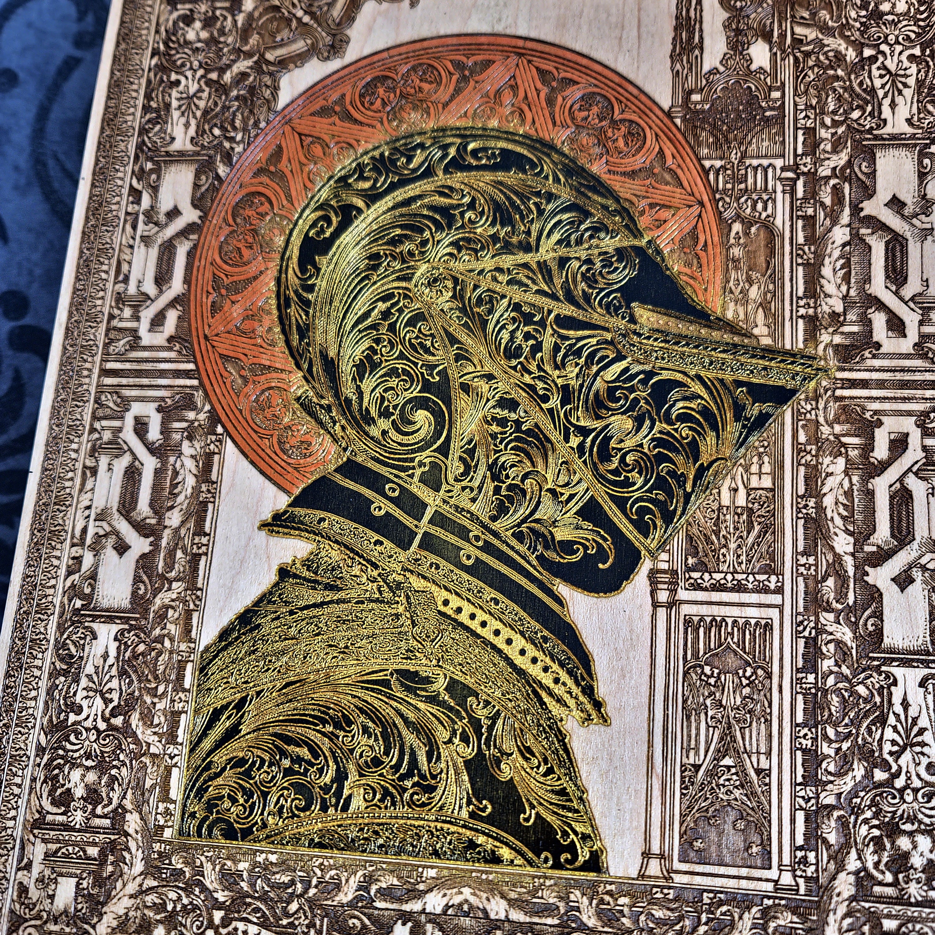 Black-and-gold medieval knight helmet maple wood wall art, close-up portrait of the engraved knight helmet and armour