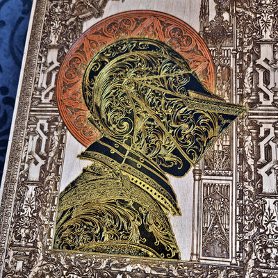 Black-and-gold medieval knight helmet maple wood wall art, close-up portrait of the engraved knight helmet and armour