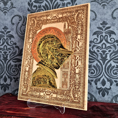 Black-and-gold medieval knight helmet maple wood wall art, angled unframed view showing the maple panel
