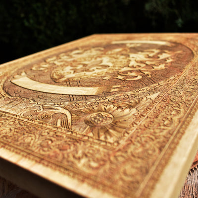 Laser-engraved coat of arms on dark wood, personalized with family motto.