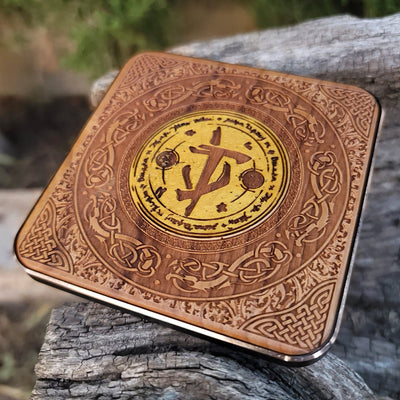 Close-up of Doom-inspired symbol on wooden wireless charger.