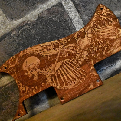 Close-up of laser-engraved Stumble Skeleton artwork on Epiphone SG cherry wood pickguard