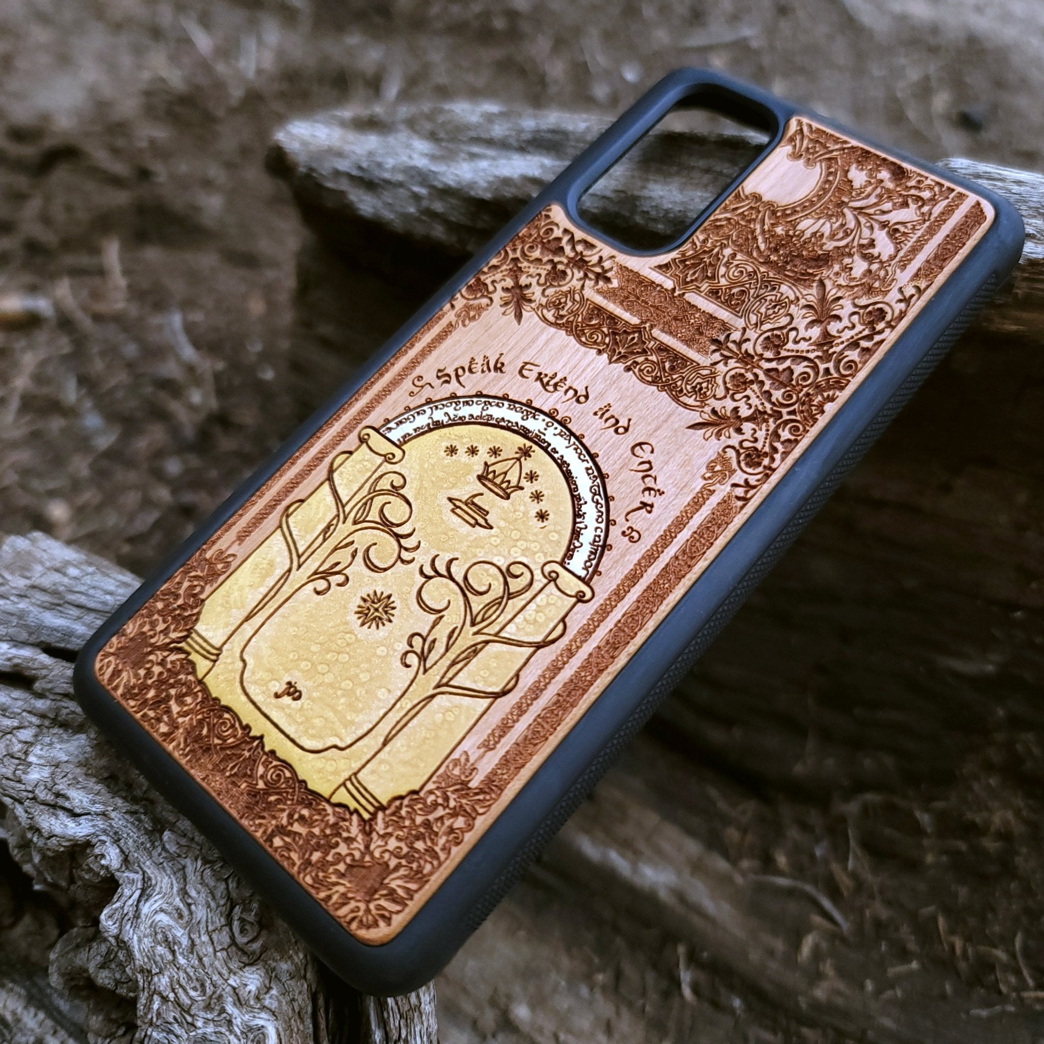 Wooden phone case featuring a gothic Lord of the Rings-inspired design of the Gate of Moria. The intricate laser-engraving showcases the iconic dwarven door from the Mines of Moria, adorned with Elvish script and decorative elements. Compatible with iPhone , 15, 14, 13, 12, 11 Pro Max Mini and Samsung Galaxy S, S24, S23, S22, S21, S20 Ultra, Plus, Note 20. A unique and durable accessory perfect for fans of Tolkien’s Middle-earth.