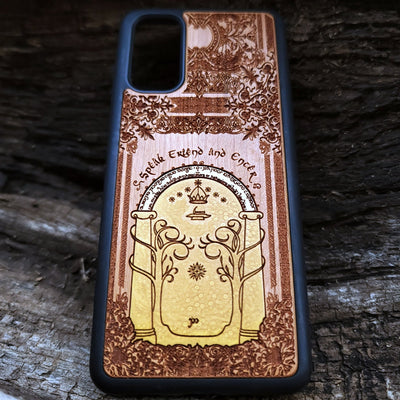 Wooden phone case featuring a gothic Lord of the Rings-inspired design of the Gate of Moria. The intricate laser-engraving showcases the iconic dwarven door from the Mines of Moria, adorned with Elvish script and decorative elements. Compatible with iPhone , 15, 14, 13, 12, 11 Pro Max Mini and Samsung Galaxy S, S24, S23, S22, S21, S20 Ultra, Plus, Note 20. A unique and durable accessory perfect for fans of Tolkien’s Middle-earth.