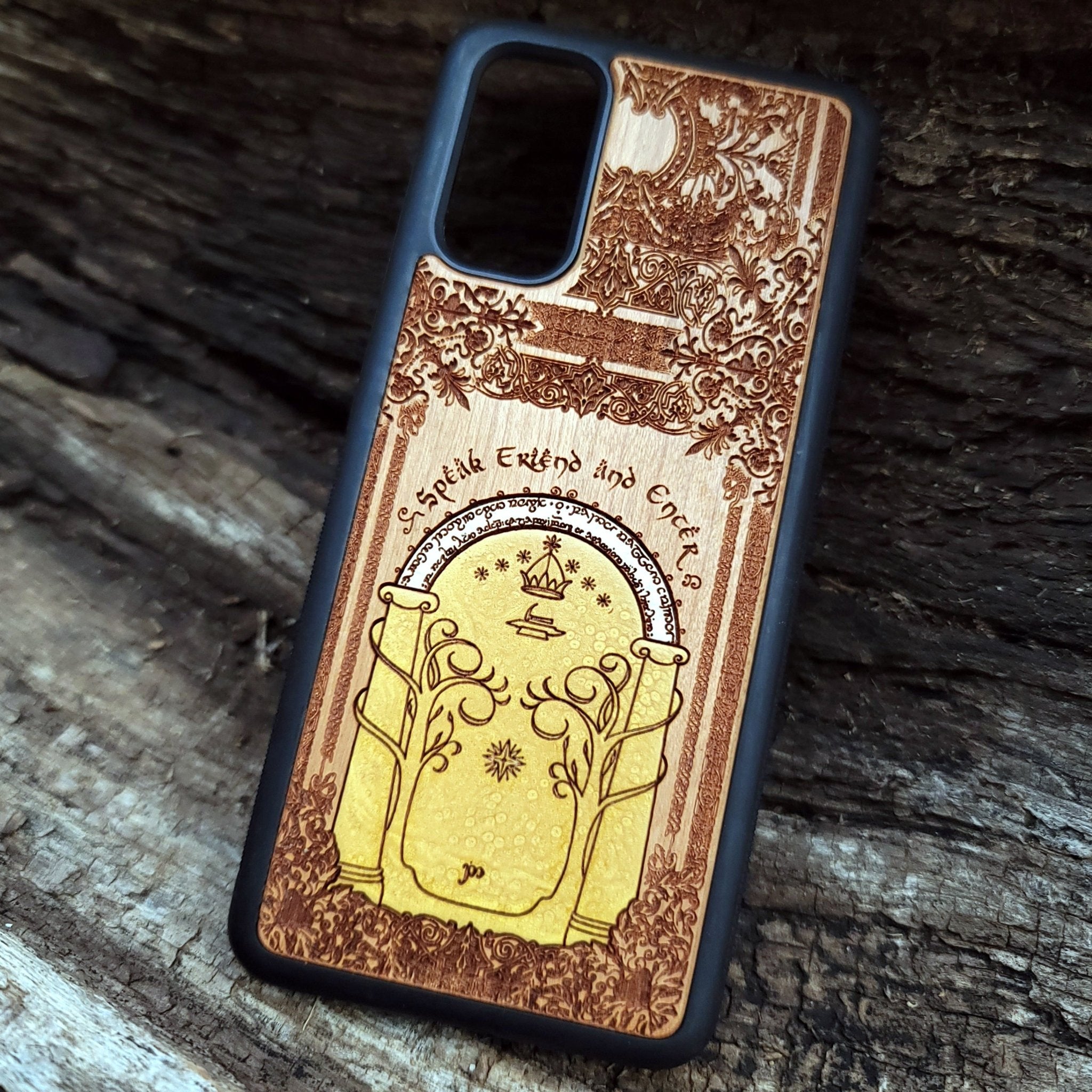 Wooden phone case featuring a gothic Lord of the Rings-inspired design of the Gate of Moria. The intricate laser-engraving showcases the iconic dwarven door from the Mines of Moria, adorned with Elvish script and decorative elements. Compatible with iPhone , 15, 14, 13, 12, 11 Pro Max Mini and Samsung Galaxy S, S24, S23, S22, S21, S20 Ultra, Plus, Note 20. A unique and durable accessory perfect for fans of Tolkien’s Middle-earth.