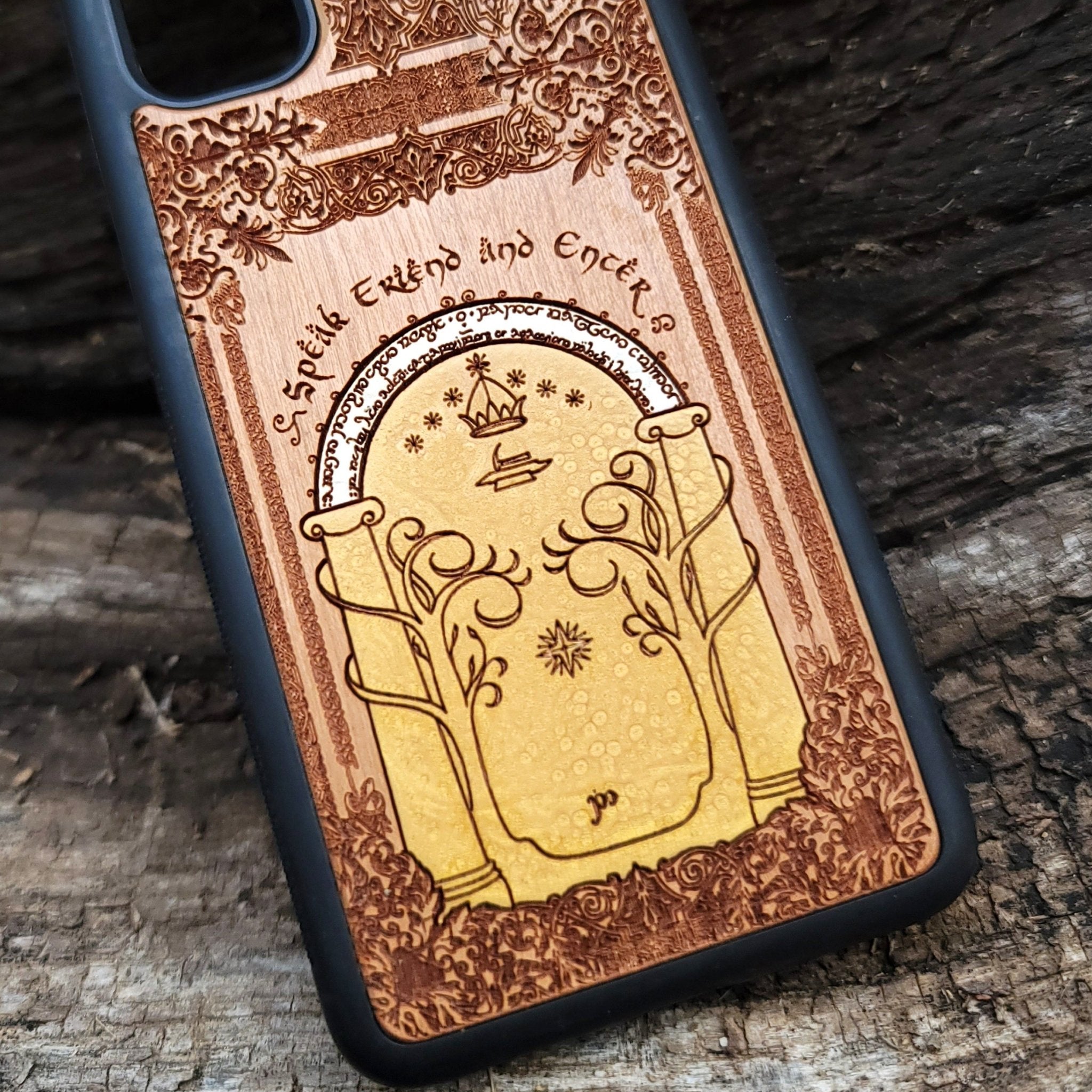 Wooden phone case featuring a gothic Lord of the Rings-inspired design of the Gate of Moria. The intricate laser-engraving showcases the iconic dwarven door from the Mines of Moria, adorned with Elvish script and decorative elements. Compatible with iPhone , 15, 14, 13, 12, 11 Pro Max Mini and Samsung Galaxy S, S24, S23, S22, S21, S20 Ultra, Plus, Note 20. A unique and durable accessory perfect for fans of Tolkien’s Middle-earth.