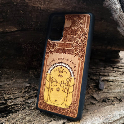 Wooden phone case featuring a gothic Lord of the Rings-inspired design of the Gate of Moria. The intricate laser-engraving showcases the iconic dwarven door from the Mines of Moria, adorned with Elvish script and decorative elements. Compatible with iPhone , 15, 14, 13, 12, 11 Pro Max Mini and Samsung Galaxy S, S24, S23, S22, S21, S20 Ultra, Plus, Note 20. A unique and durable accessory perfect for fans of Tolkien’s Middle-earth.