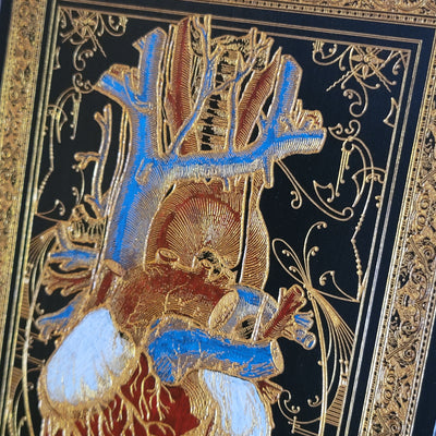 Laser-engraved heart art on wood, painted in dark gothic tones with gold.