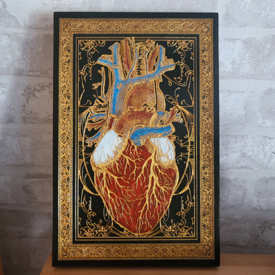 Black and gold anatomical heart wood wall art, perfect for gothic home decor.