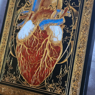 Unique heart engraving with gold paint on dark wood, ideal for medical decor.