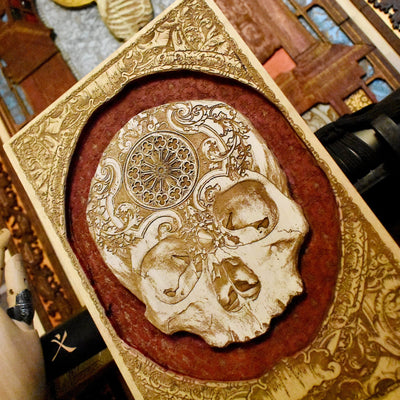 Handcrafted wooden skull panel with intricate carvings