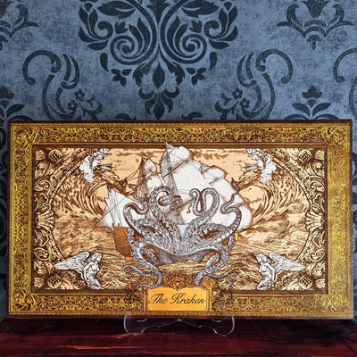 Kraken engraved wood wall art with giant octopus attacking sailing ship, ocean waves and hand painted ornate gold nautical frame