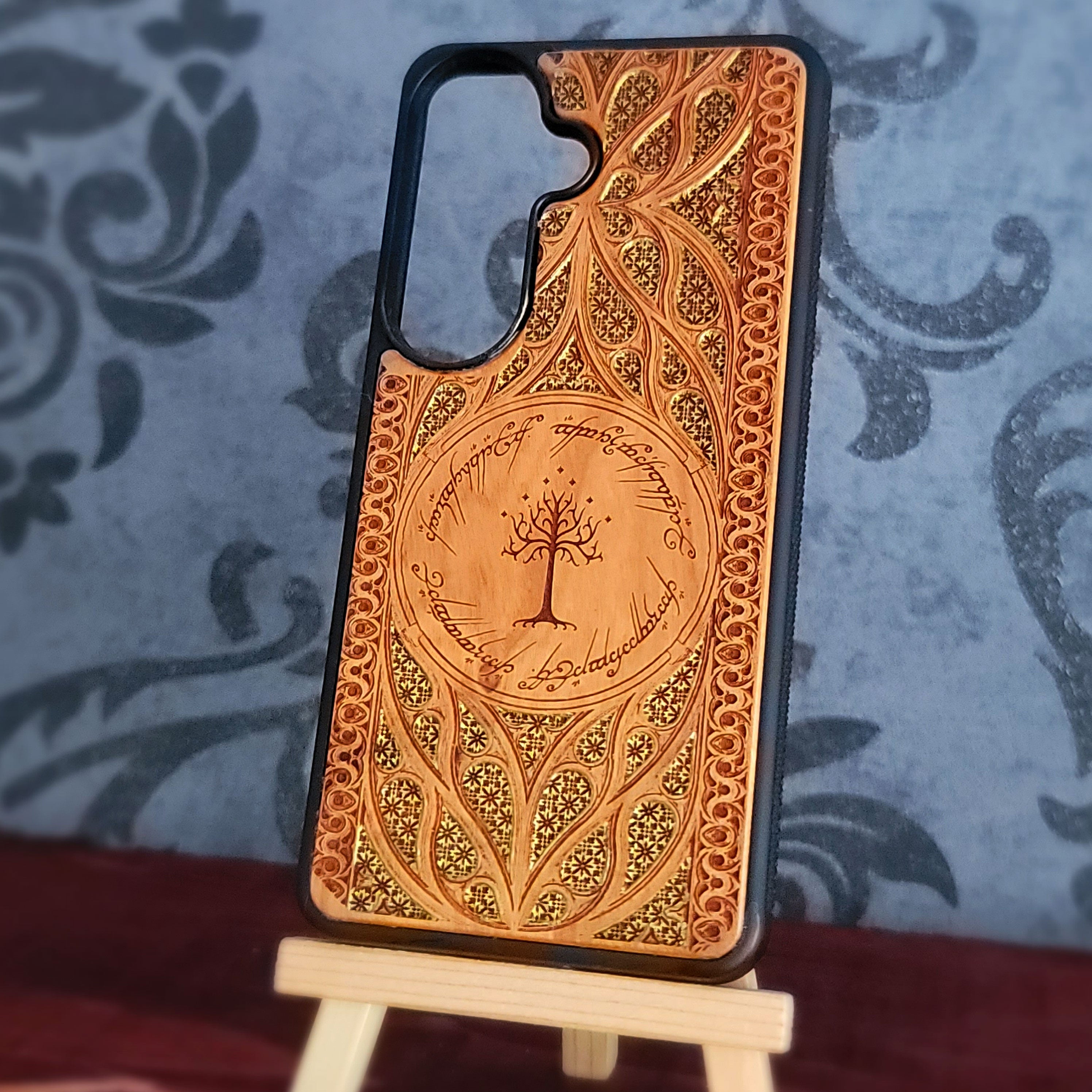 Lord of the Rings wood phone case featuring the White Tree of Gondor surrounded by Elvish script and intricate, detailed patterns.