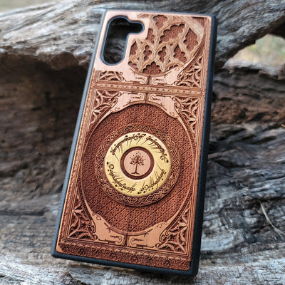 Close-up of intricate laser-engraved Tolkien-inspired design on handcrafted cherry wood phone case.