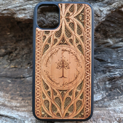 Lord of the Rings wood phone case featuring the White Tree of Gondor surrounded by Elvish script and intricate, detailed patterns. Laser-engraved with precision and a natural wood finish, this durable case is compatible with iPhone , 15, 14, 13, 12, 11, Pro Max, Mini, and Samsung Galaxy S, S24, S23, S22, S21, S20 Ultra, Plus, Note 20. A stylish and protective accessory for Tolkien fans.
