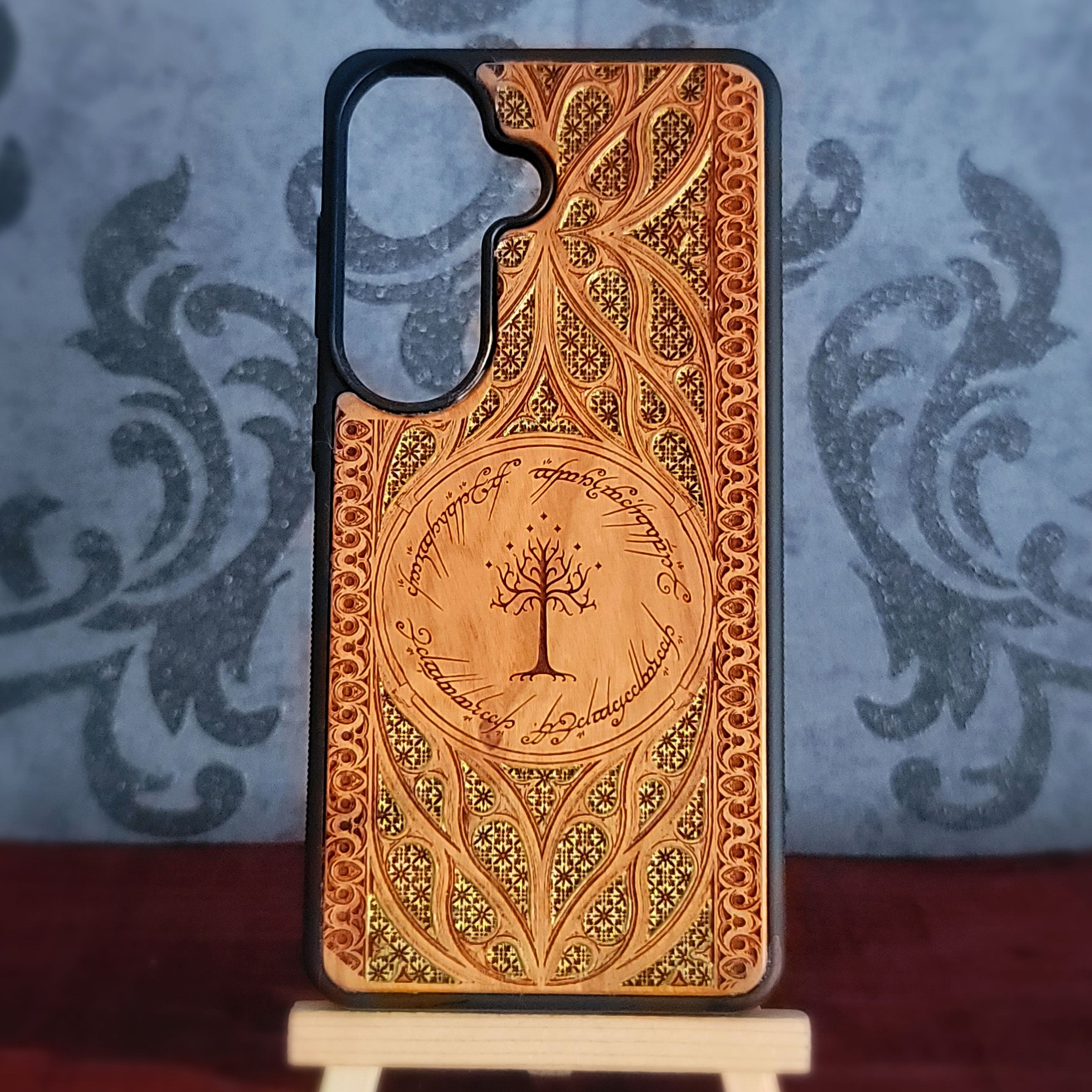 Lord of the Rings wood phone case featuring the White Tree of Gondor surrounded by Elvish script and intricate, detailed patterns.