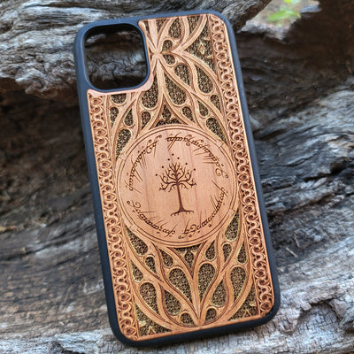 Lord of the Rings wood phone case featuring the White Tree of Gondor surrounded by Elvish script and intricate, detailed patterns. Laser-engraved with precision and a natural wood finish, this durable case is compatible with iPhone , 15, 14, 13, 12, 11, Pro Max, Mini, and Samsung Galaxy S, S24, S23, S22, S21, S20 Ultra, Plus, Note 20. A stylish and protective accessory for Tolkien fans.