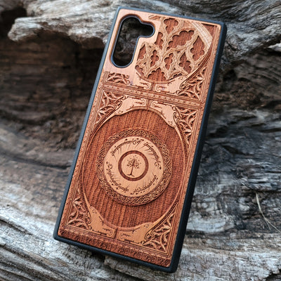 Wooden phone case featuring a gothic Lord of the Rings-inspired design with intricate engravings of the iconic White Tree of Gondor and Elvish script. The laser-engraved details capture the elegance and mystique of Tolkien’s world, perfect for fans of Middle-earth. Compatible with iPhone , 15, 14, 13, 12, 11 Pro Max Mini, and Samsung Galaxy S, S24, S23, S22, S21, S20 Ultra, Plus, Note 20. A unique, durable, and stylish accessory for LOTR enthusiasts.