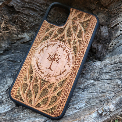 Lord of the Rings wood phone case featuring the White Tree of Gondor surrounded by Elvish script and intricate, detailed patterns. Laser-engraved with precision and a natural wood finish, this durable case is compatible with iPhone , 15, 14, 13, 12, 11, Pro Max, Mini, and Samsung Galaxy S, S24, S23, S22, S21, S20 Ultra, Plus, Note 20. A stylish and protective accessory for Tolkien fans.