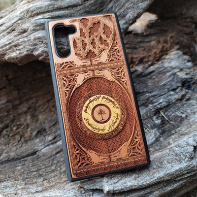 Wooden phone case featuring a gothic Lord of the Rings-inspired design, intricately laser-engraved with the iconic Eye of Sauron and Elvish script. The detailed engraving brings a dark, elegant touch to your phone, capturing the essence of Tolkien’s Middle-earth. Compatible with iPhone , 15, 14, 13, 12, 11 Pro Max Mini and Samsung Galaxy S, S24, S23, S22, S21, S20 Ultra, Plus, Note 20. A perfect, durable accessory for fans of the Lord of the Rings saga.