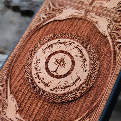 Wooden phone case featuring a gothic Lord of the Rings-inspired design with intricate engravings of the iconic White Tree of Gondor and Elvish script. The laser-engraved details capture the elegance and mystique of Tolkien’s world, perfect for fans of Middle-earth. Compatible with iPhone , 15, 14, 13, 12, 11 Pro Max Mini, and Samsung Galaxy S, S24, S23, S22, S21, S20 Ultra, Plus, Note 20. A unique, durable, and stylish accessory for LOTR enthusiasts.