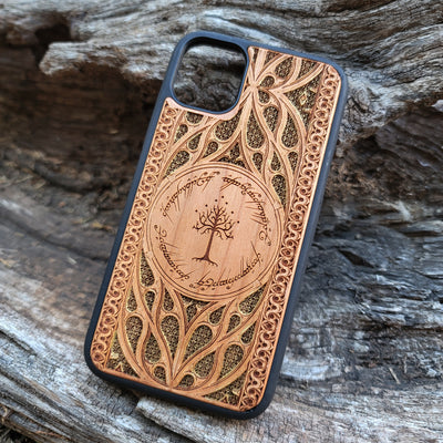 Lord of the Rings wood phone case featuring the White Tree of Gondor surrounded by Elvish script and intricate, detailed patterns. Laser-engraved with precision and a natural wood finish, this durable case is compatible with iPhone , 15, 14, 13, 12, 11, Pro Max, Mini, and Samsung Galaxy S, S24, S23, S22, S21, S20 Ultra, Plus, Note 20. A stylish and protective accessory for Tolkien fans.