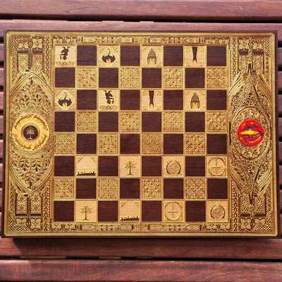 Handcrafted walnut chess board with gold-stained Lord of the Rings engravings, perfect for 5-year anniversaries.