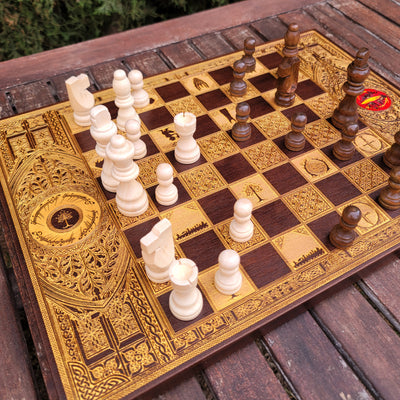 Luxury wooden chess set featuring laser-engraved Tolkien-inspired gold artwork on walnut wood.