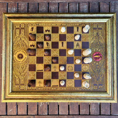 Handcrafted walnut chess board with gold-stained Lord of the Rings engravings, perfect for 5-year anniversaries.
