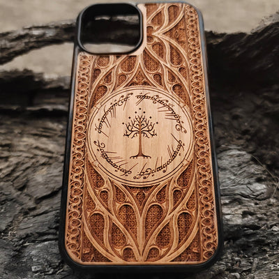 Lord of the Rings wood phone case featuring the White Tree of Gondor surrounded by Elvish script and intricate detailing. Laser-engraved for a unique and elegant design, this durable case is compatible with iPhone , 15, 14, 13, 12, 11, Pro Max, Mini, and Samsung Galaxy S, S24, S23, S22, S21, S20 Ultra, Plus, Note 20. Perfect for Tolkien fans seeking a stylish and protective accessory.