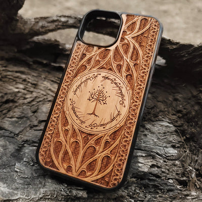 Lord of the Rings wood phone case featuring the White Tree of Gondor surrounded by Elvish script and intricate detailing. Laser-engraved for a unique and elegant design, this durable case is compatible with iPhone , 15, 14, 13, 12, 11, Pro Max, Mini, and Samsung Galaxy S, S24, S23, S22, S21, S20 Ultra, Plus, Note 20. Perfect for Tolkien fans seeking a stylish and protective accessory.