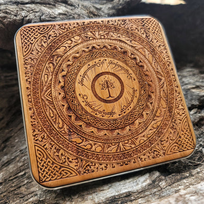 Wooden wireless charger engraved with Tolkien-inspired symbols.