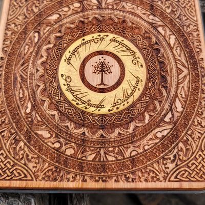 Close-up of elven script from Middle-earth on wooden charger.