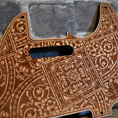 Close-up of laser-engraved cherry wood pickguard for Fender Telecaster