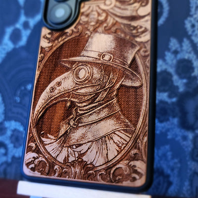 Deep laser engraved wooden phone case featuring a gothic Plague Doctor design on natural wood for iPhone and Samsung Galaxy.