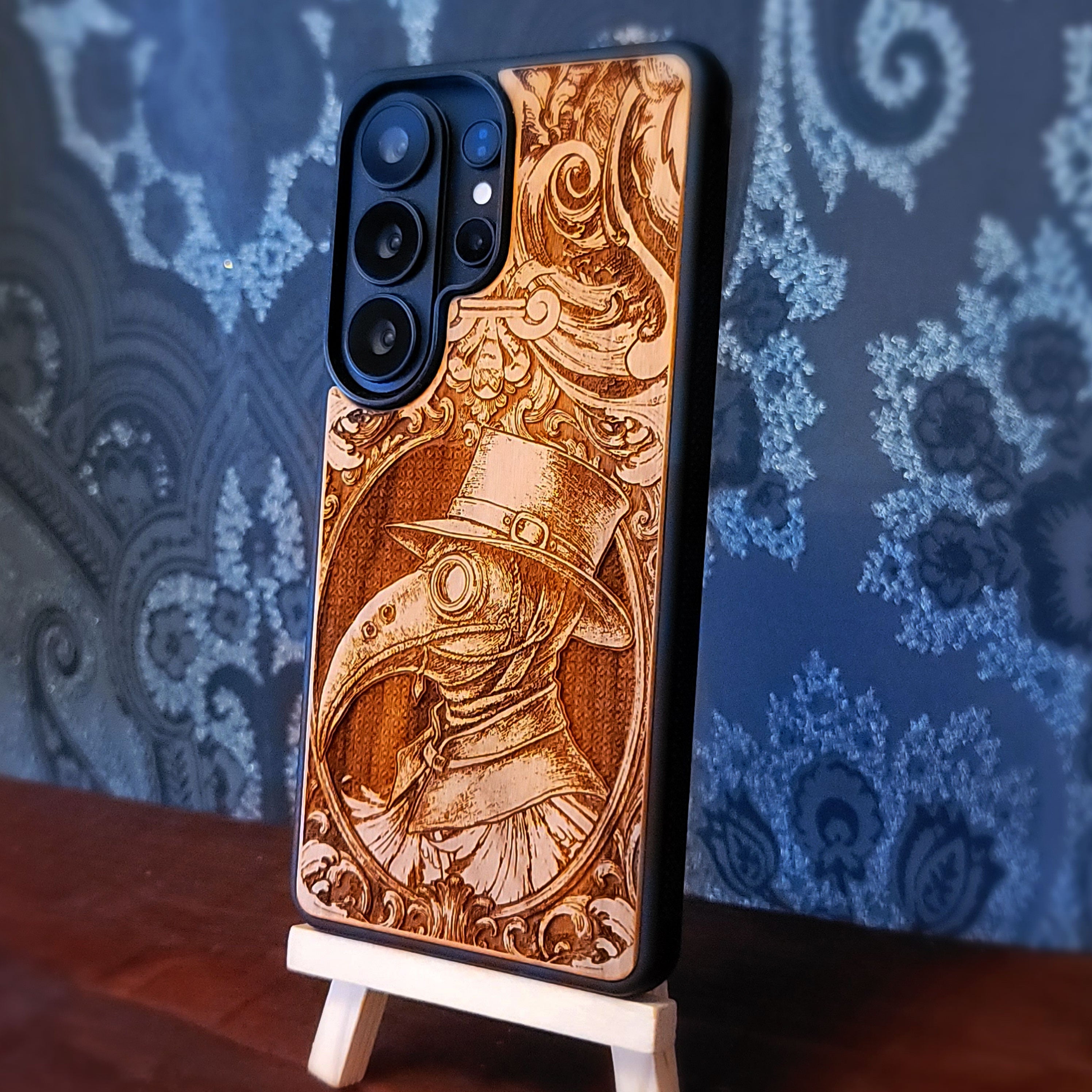 Deep laser engraved wooden phone case featuring a gothic Plague Doctor design on natural wood for iPhone and Samsung Galaxy.