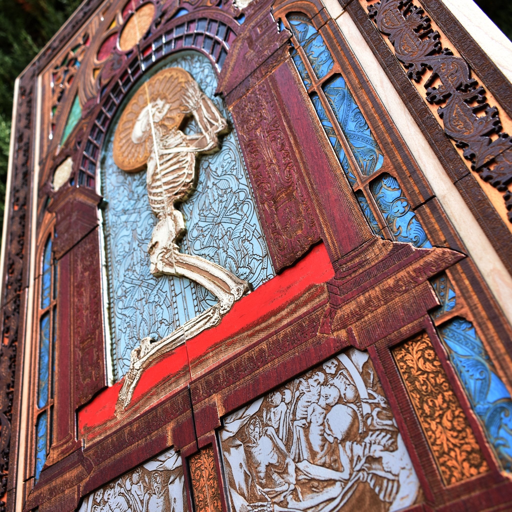 Hand-engraved wood art of a praying skeleton, ideal for vintage horror decor.