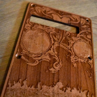 ack of Stratocaster fitted with custom tremolo cover – laser-engraved detail