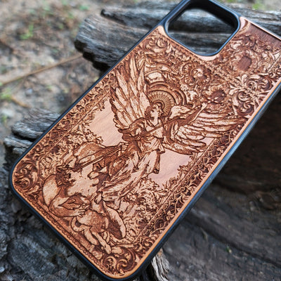 Wood phone case featuring religious artwork of Saint Michael the Archangel, engraved for iPhone  and Samsung Galaxy S with intricate detailing of the archangel defeating the devil.