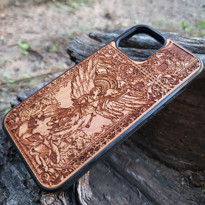 Wood phone case featuring religious artwork of Saint Michael the Archangel, engraved for iPhone  and Samsung Galaxy S with intricate detailing of the archangel defeating the devil.