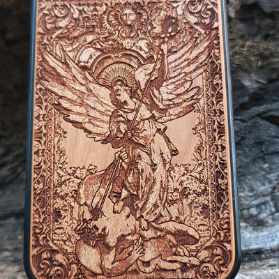 Wood phone case featuring religious artwork of Saint Michael the Archangel, engraved for iPhone  and Samsung Galaxy S with intricate detailing of the archangel defeating the devil.