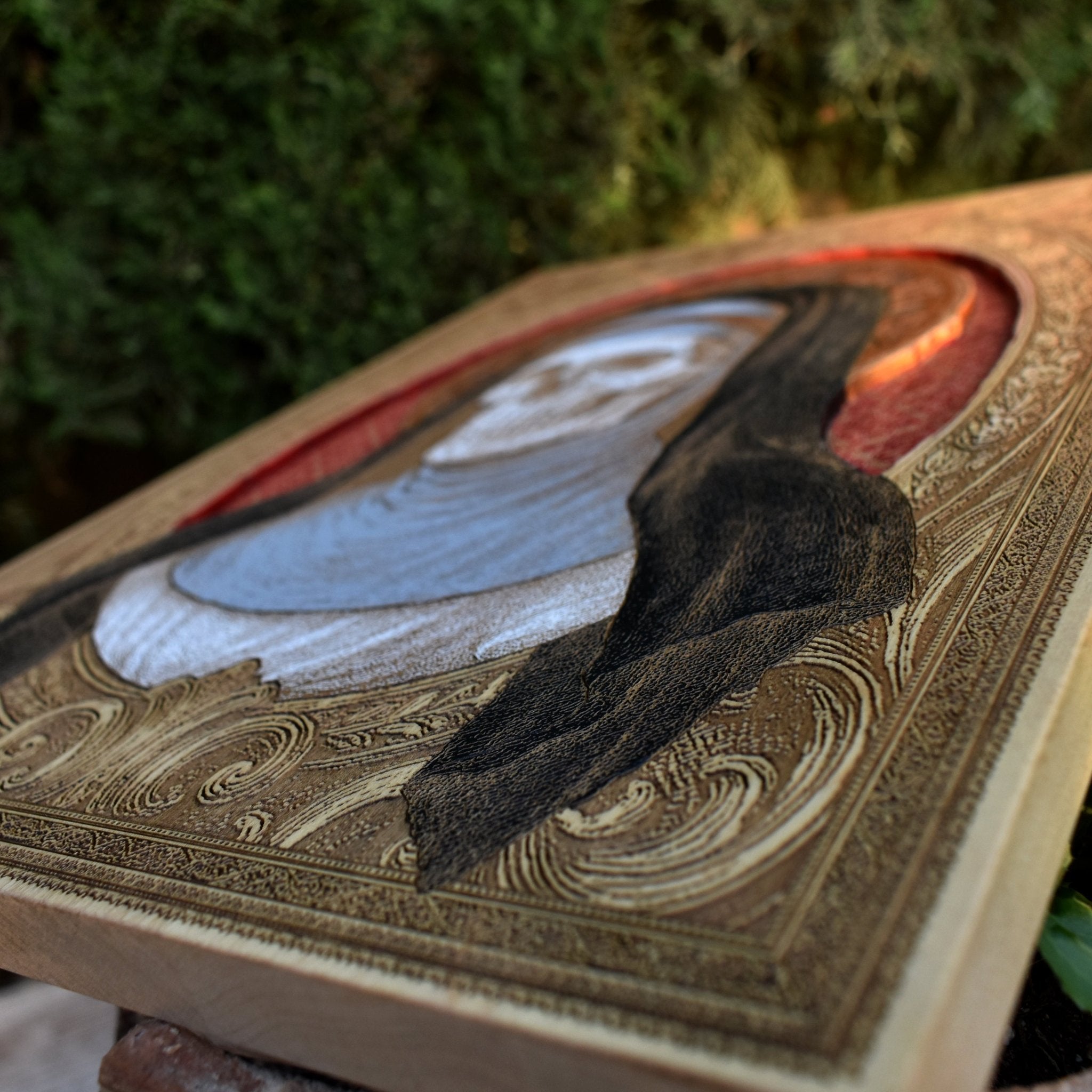 Handcrafted symbolic artwork of a sister alongside a skull on wood.