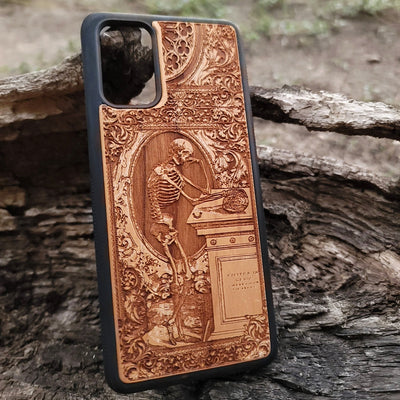 Wooden phone case with a gothic thinking skeleton design, intricately carved for iPhone , iPhone 15, Galaxy S23 Ultra, Note 20, and more. Perfect for gothic art lovers and unique phone accessories.