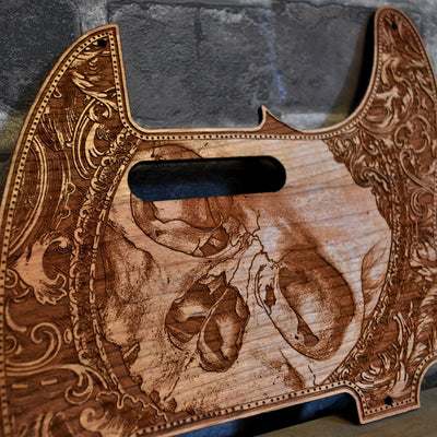 Close-up of detailed skull engraving on cherry wood Fender Telecaster pickguard