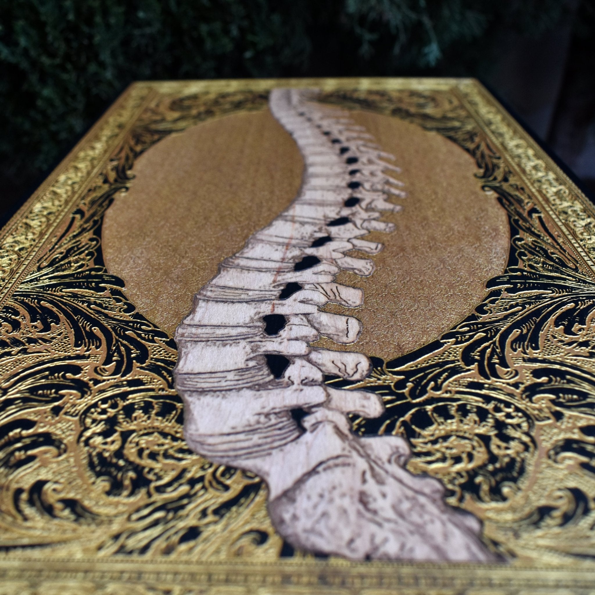 Engraved wooden skull artwork with gothic and horror aesthetics. A unique statement piece with intricate details and gold accents.