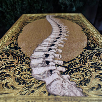 Engraved wooden skull artwork with gothic and horror aesthetics. A unique statement piece with intricate details and gold accents.