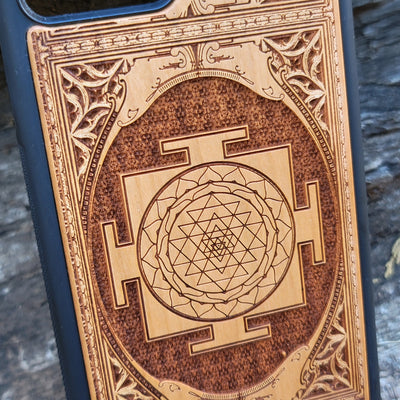 Wood phone case for iPhone & Samsung Galaxy featuring intricate Sri Yantra Chakra design. Laser-engraved with Gothic patterns, offering a unique, spiritual aesthetic. Slim, durable, and compatible with iPhone 15, 14, 13, 12, 11 Pro Max Mini & Samsung Galaxy S24, S23, S22, S21, S20 Ultra Plus Note 20. Stylish, protective, and personalized—order now!