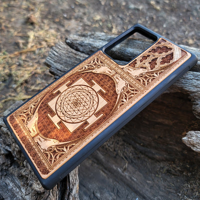 Wood phone case for iPhone & Samsung Galaxy featuring intricate Sri Yantra Chakra design. Laser-engraved with Gothic patterns, offering a unique, spiritual aesthetic. Slim, durable, and compatible with iPhone 15, 14, 13, 12, 11 Pro Max Mini & Samsung Galaxy S24, S23, S22, S21, S20 Ultra Plus Note 20. Stylish, protective, and personalized—order now!
