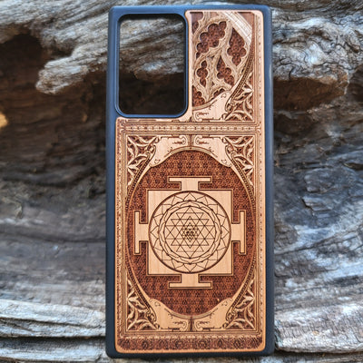 Wood phone case for iPhone & Samsung Galaxy featuring intricate Sri Yantra Chakra design. Laser-engraved with Gothic patterns, offering a unique, spiritual aesthetic. Slim, durable, and compatible with iPhone 15, 14, 13, 12, 11 Pro Max Mini & Samsung Galaxy S24, S23, S22, S21, S20 Ultra Plus Note 20. Stylish, protective, and personalized—order now!