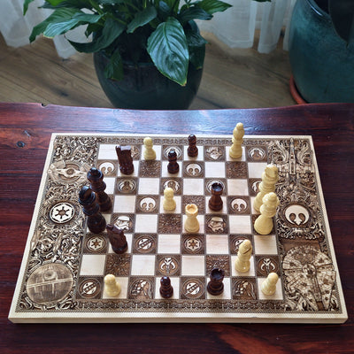 Detailed laser engraved sci fi chessboard with ornate space themed border and wooden chess pieces